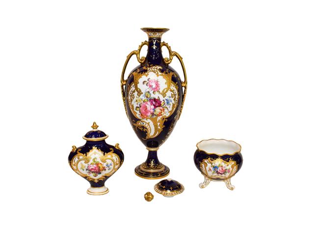 Lot 21 - Royal Crown Derby: A gilt and cobalt blue twin-handled covered vase painted with floral sprays...
