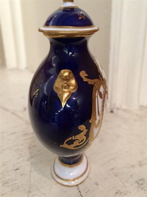Lot 21 - Royal Crown Derby: A gilt and cobalt blue twin-handled covered vase painted with floral sprays...