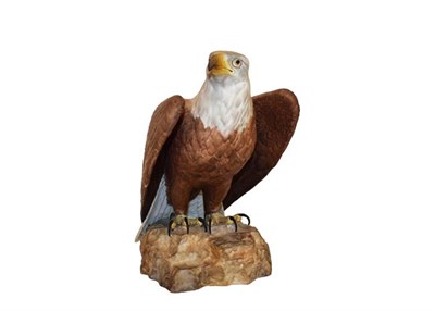Lot 37 - A Royal Crown Derby porcelain model of a Bald Eagle standing on a rocky outcrop, 25cm high...