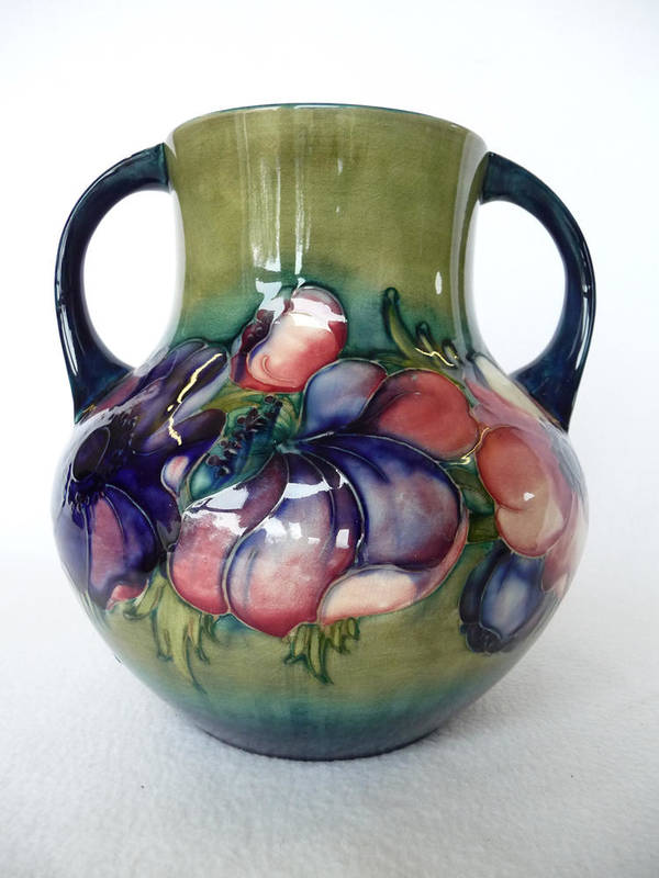 Lot 1731 - A Walter Moorcroft Anemone Pattern Twin-Handled Vase, circa 1950, on a green and blue ground,...