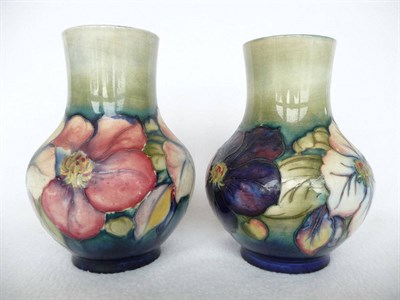 Lot 1732 - Two Walter Moorcroft Clematis Pattern Vases, circa 1950, both on a blue/green ground, blue...