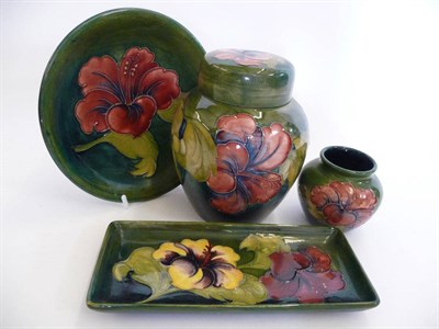 Lot 1734 - A Walter Moorcroft Hibiscus Pattern 769 Ginger Jar and Cover, on a green ground, impressed...