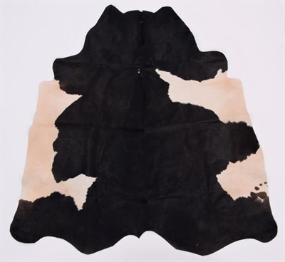 Lot 201 - Hides/Skins: A Collection of Cow & Calf Hides, modern, a large Cow hide rug, printed as a...