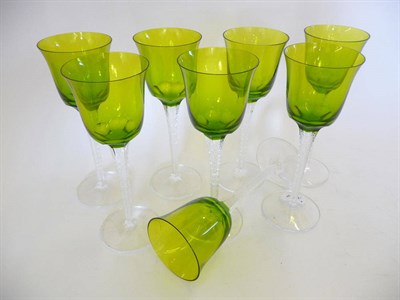 Lot 1769 - A Set of Eight Lalique Treves Hock Glasses, each with olive green glass bowl, raised on a...