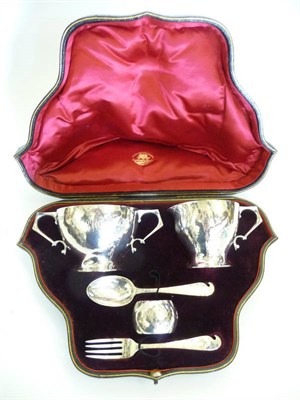 Lot 1773 - An Arts & Crafts Silver Christening Set, by Goldsmiths and Silversmiths, London 1901,...