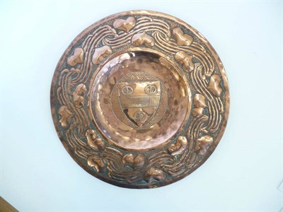 Lot 1775 - An Arts & Crafts Copper Charger, the centre decorated with a crest containing three Penannular...