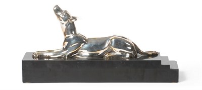 Lot 1782 - Attributed to D H Chiparus: A Silvered Bronze Figure of a Dog, in a reclining pose with head...