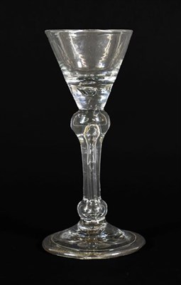 Lot 6 - A Cordial Glass, circa 1710, the wide conical bowl with basal air tear on an inverted baluster stem