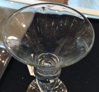 Lot 10 - A Wine Glass, circa 1730, the thistle shaped bowl with air tear to solid base, on a ball...