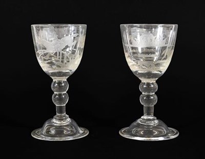 Lot 12 - A Pair of Wine Glasses, circa 1740, the rounded funnel bowls later engraved with hunting scenes, on