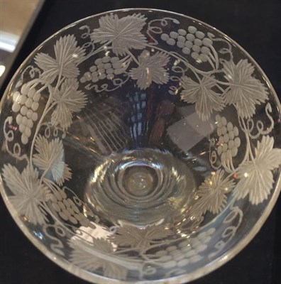 Lot 13 - A Wine Glass, 1740, the drawn trumpet bowl engraved with fruiting vine on a baluster stem,...