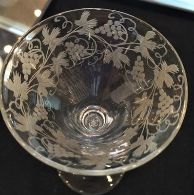 Lot 14 - A Wine Glass, 1740, the drawn trumpet bowl engraved with fruiting vine on a baluster stem,...