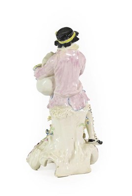 Lot 35 - A Bow Porcelain Figure of a Bagpiper, circa 1765, seated on a rocky outcrop on a scroll moulded...