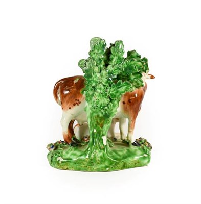 Lot 59 - A Matched Pair of Derby Porcelain Cow and Calf Groups, circa 1780, each on mound bases with bocage