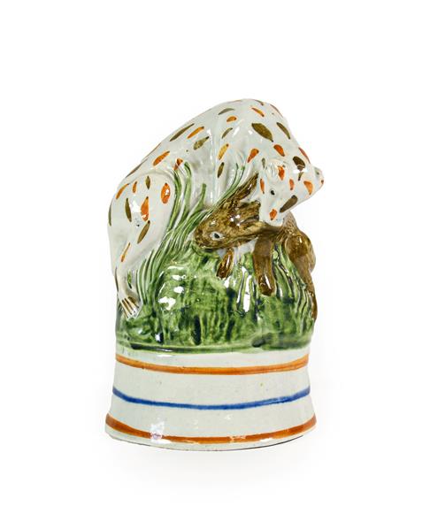 Lot 75 - A Pratt Type Stirrup Cup, circa 1800, as a hound catching a hare on a grassy mound and blue and...