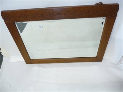 Lot 1809 - A Robert "Mouseman" Thompson Oak Rectangular Mirror, with castellated top, bevelled edge plate...