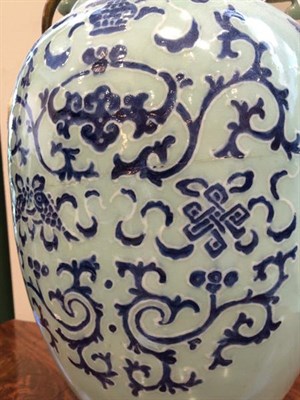 Lot 161 - A Chinese Porcelain Baluster Vase, 19th century, with stylised beast handles, painted in underglaze