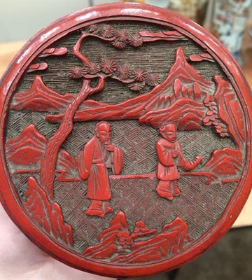 Lot 174 - A Chinese Cinnabar Lacquer Box and Cover, Qing Dynasty, of cylindrical form, carved with figures in