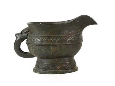 Lot 177 - A Chinese Bronze Ewer, in Archaistic style, of oval form with mask and loop handle and with foliate