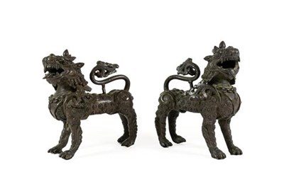 Lot 178 - A Pair of Chinese Bronze Temple Guardians, Qing Dynasty, 19th century, modelled as kylins...