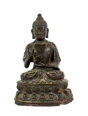Lot 179 - A Chinese Bronze Figure of Buddha, in 17th/18th century style, sitting cross-legged, one hand...