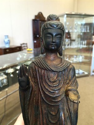 Lot 180 - A Chinese Bronze Figure of Buddha, 18th/19th century, standing wearing flowing robes, both...