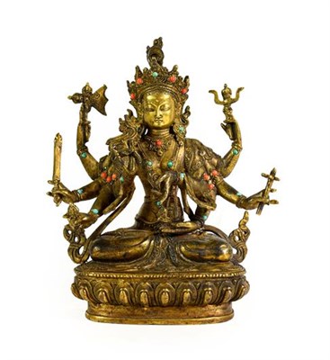Lot 182 - A Sino-Tibetan Gilt Bronze Figure of a Bodhisattva, probably 17th/18th century, the eight-armed...