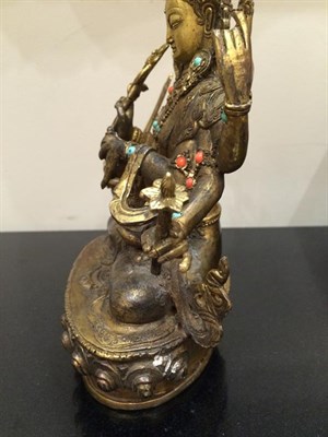 Lot 182 - A Sino-Tibetan Gilt Bronze Figure of a Bodhisattva, probably 17th/18th century, the eight-armed...