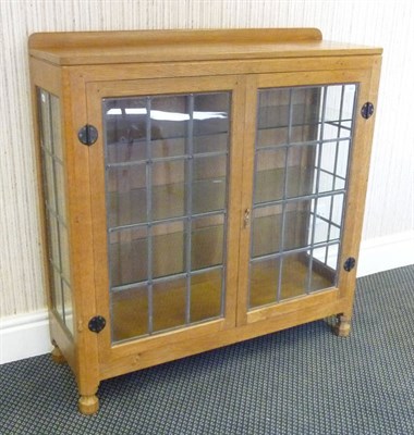 Lot 1820 - A Robert "Mouseman" Thompson Oak Display Cupboard, with raised upstand, above two leaded glazed...