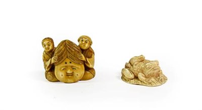 Lot 209 - A Japanese Ivory Netsuke, Meiji period, carved as a toad on a lily pad, its young on its back,...