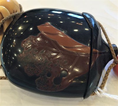 Lot 210 - A Japanese Lacquer Inro, Meiji period, in the form of a fruit, decorated with a leaf, 7.5cm, with a