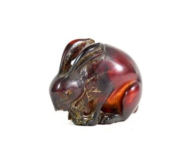 Lot 212 - A Japanese Amber Netsuke, Meiji period, naturalistically carved as a crouching rabbit, 5cm long