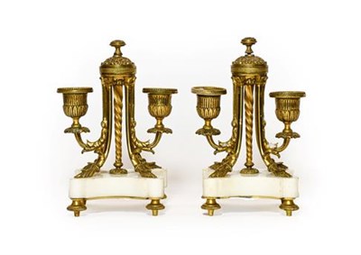 Lot 264 - A Pair of French Gilt Metal and White Marble Twin-Light Candelabra, circa 1870, with fluted campana