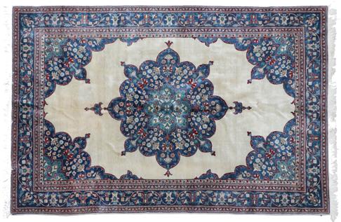 Lot 300 - Indian Carpet, 2nd half 20th century The plain cream field with indigo flower head medallion framed