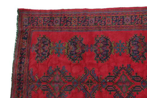 Lot 303 - Ushak Carpet West/Central Anatolia, circa 1920 The tomato red field with three rows of...