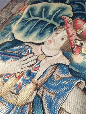 Lot 319 - A Flemish ''Tapestry'' Fragment, probably 17th century, worked in silk and wool depicting a...