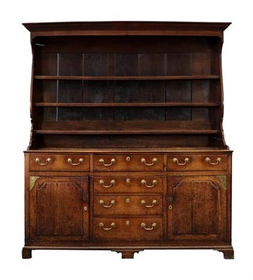 Lot 327 - A George III Oak Enclosed Dresser and Rack, late 18th century, the upper section with bold...