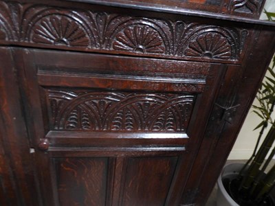 Lot 329 - A 17th Century Joined Oak Westmorland Press Cupboard, the moulded canopy above a carved frieze...