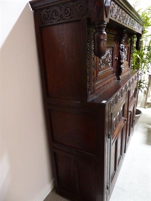 Lot 329 - A 17th Century Joined Oak Westmorland Press Cupboard, the moulded canopy above a carved frieze...