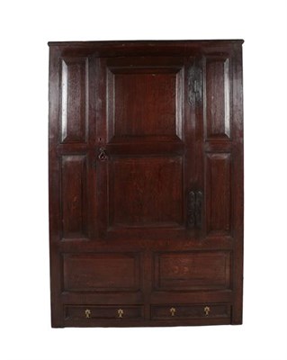 Lot 336 - A Joined Oak Clothes Press, circa 1700, with moulded panels and a central cupboard door...