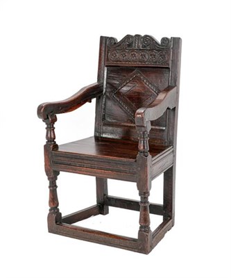 Lot 340 - A 17th Century Joined Oak English Armchair, the carved top rail above a lozenge carved back...