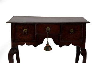 Lot 360 - A George II Oak Dressing Table, 2nd quarter 18th century, the moulded top above three small drawers