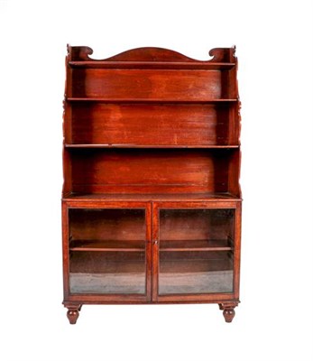 Lot 404 - A Victorian Mahogany Waterfall Glazed Bookcase, mid 19th century, the arched pediment above...