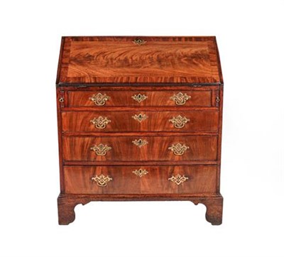 Lot 407 - A George III Mahogany and Crossbanded Bureau, late 18th century, the fall front enclosing an...