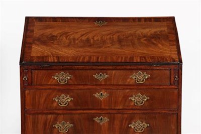 Lot 407 - A George III Mahogany and Crossbanded Bureau, late 18th century, the fall front enclosing an...