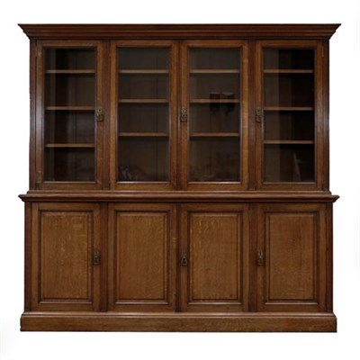 Lot 436 - A Victorian Oak Bookcase, late 19th century, the bold cornice above four glazed doors with...