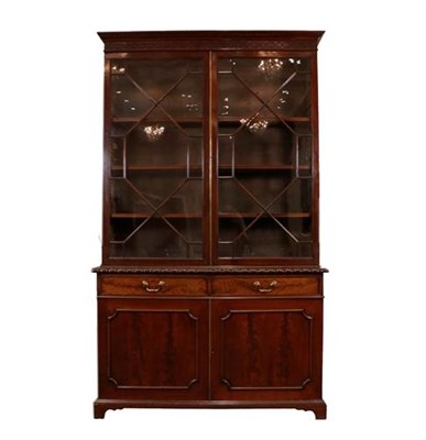 Lot 438 - A Late George III Mahogany Bookcase, early 19th century, the dentil and blind fret carved...
