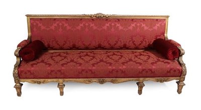Lot 442 - A French Carved Giltwood Sofa, late 19th century, in Louis XIV style, recovered in red and...