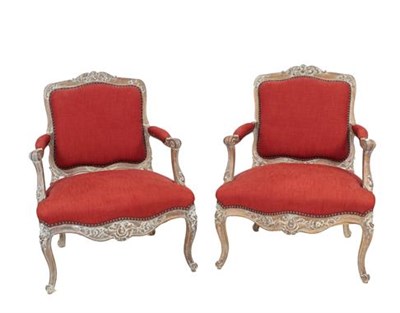 Lot 465 - A Pair of Late 19th/Early 20th Century Louis XV Style Carved Limed Oak Fauteuils, recovered in...