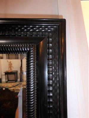 Lot 473 - A 17th Century Style Dutch Ebonised Wall Mirror, the frame with gadrooned and basketweave...
